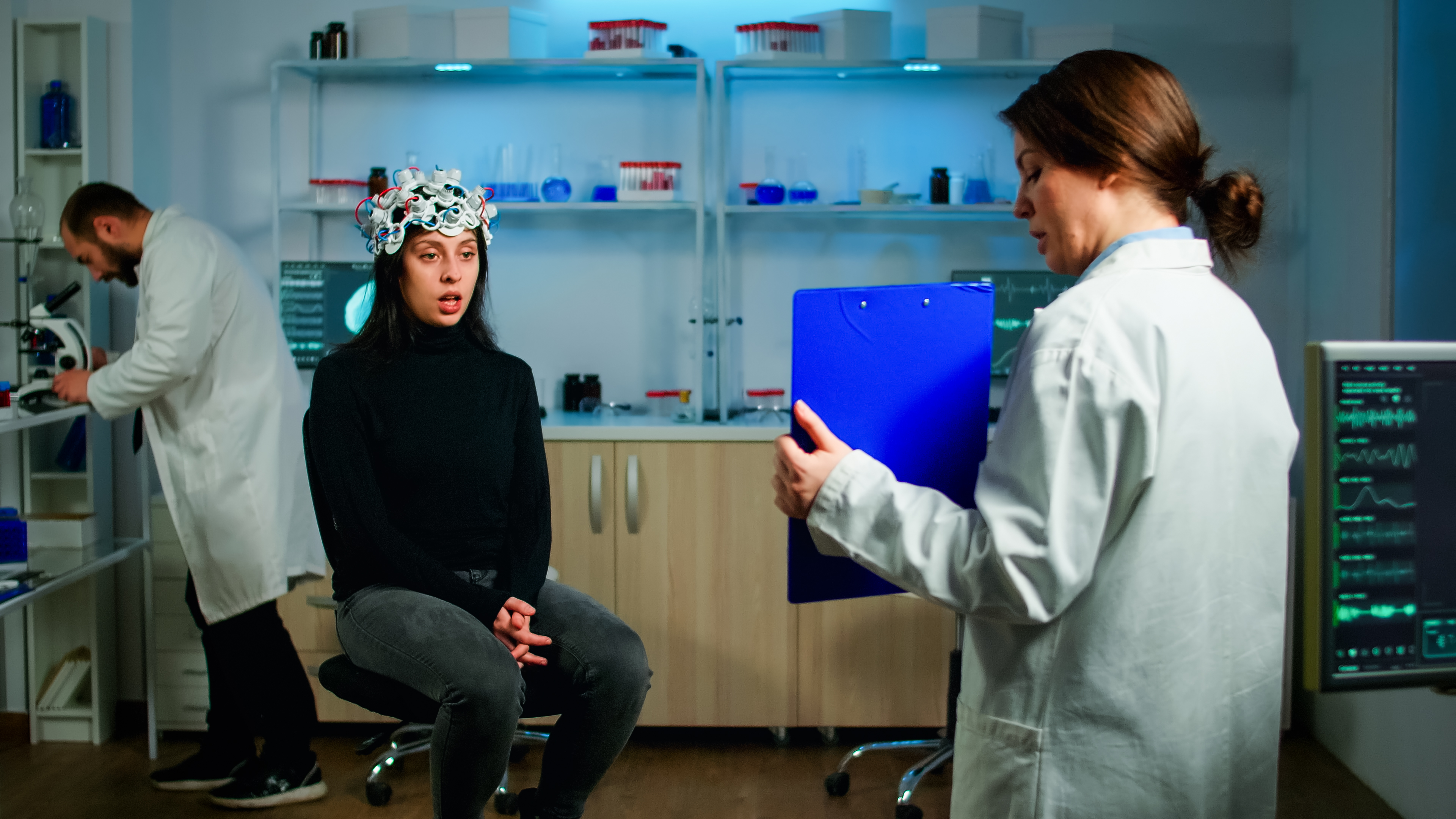Professional doctor in neurological medicine testing eyesight of patient with eeg headset. Medical reasearcher examining evolution of treatment against diseases of nervous system in equipped lab
